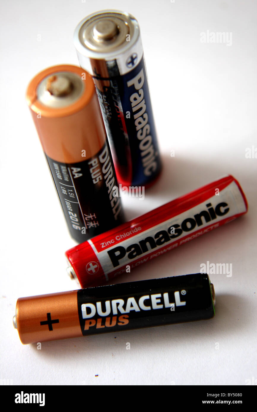 Duracell plus and Panasonic AA and AAA sized batteries on a white background Stock Photo