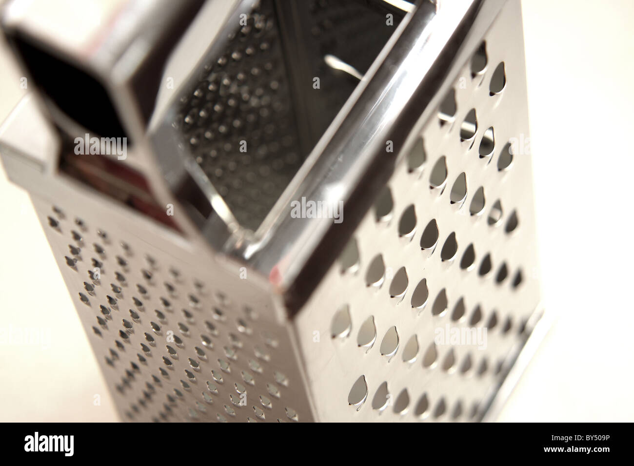 A stainless steel cheese grater used in the kitchen to grate cheese Stock Photo Alamy