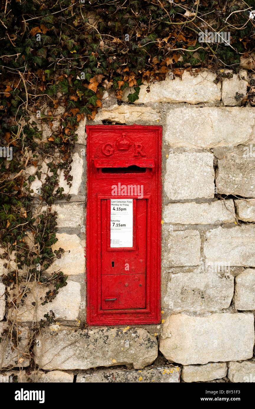 Old red GR post box set into the wall at Ruscombe near Stroud, Gloucestershire, England, United Kingdom Stock Photo