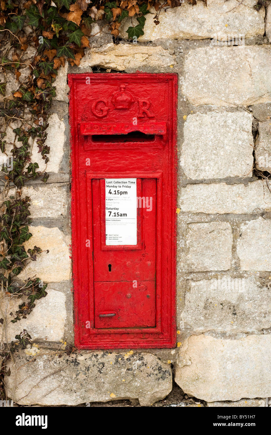 Old red GR post box set into the wall at Ruscombe near Stroud, Gloucestershire, England, United Kingdom Stock Photo