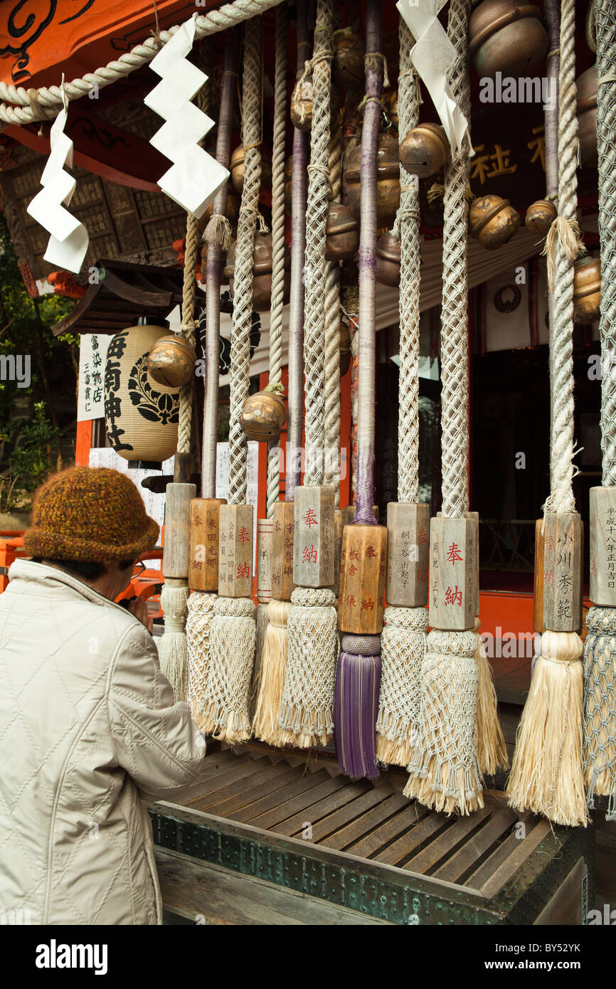 Bow twice, clap twice, then bow again.  Bells are rung with a small coin offering at a shinto shrine Stock Photo