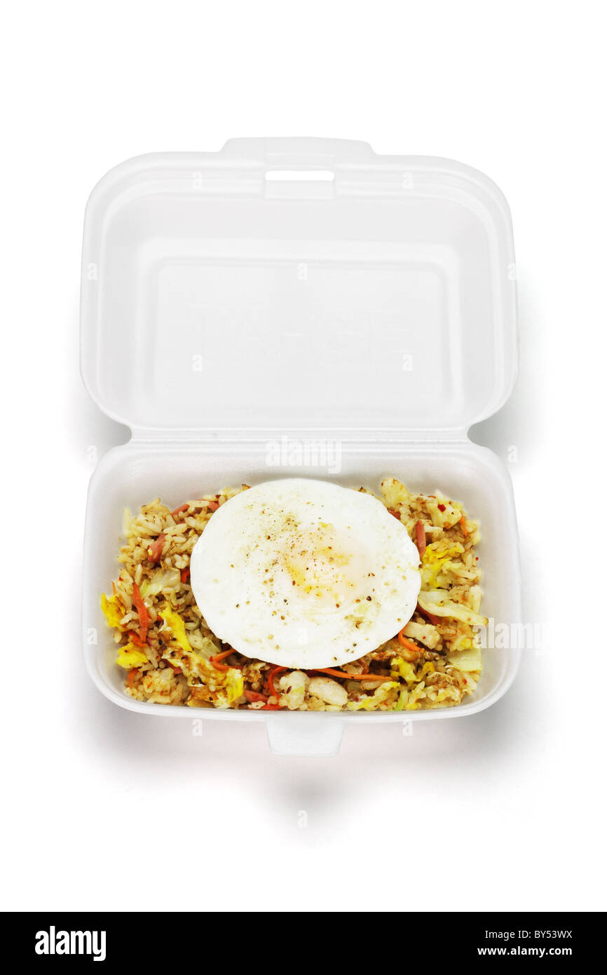 Spicy fried rice with egg in open Styrofoam box on white background Stock Photo