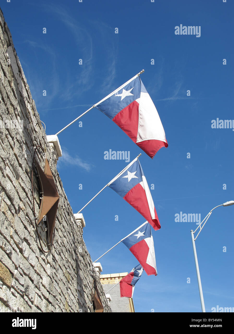 Texas flags and blue sky Stock Photo - Alamy