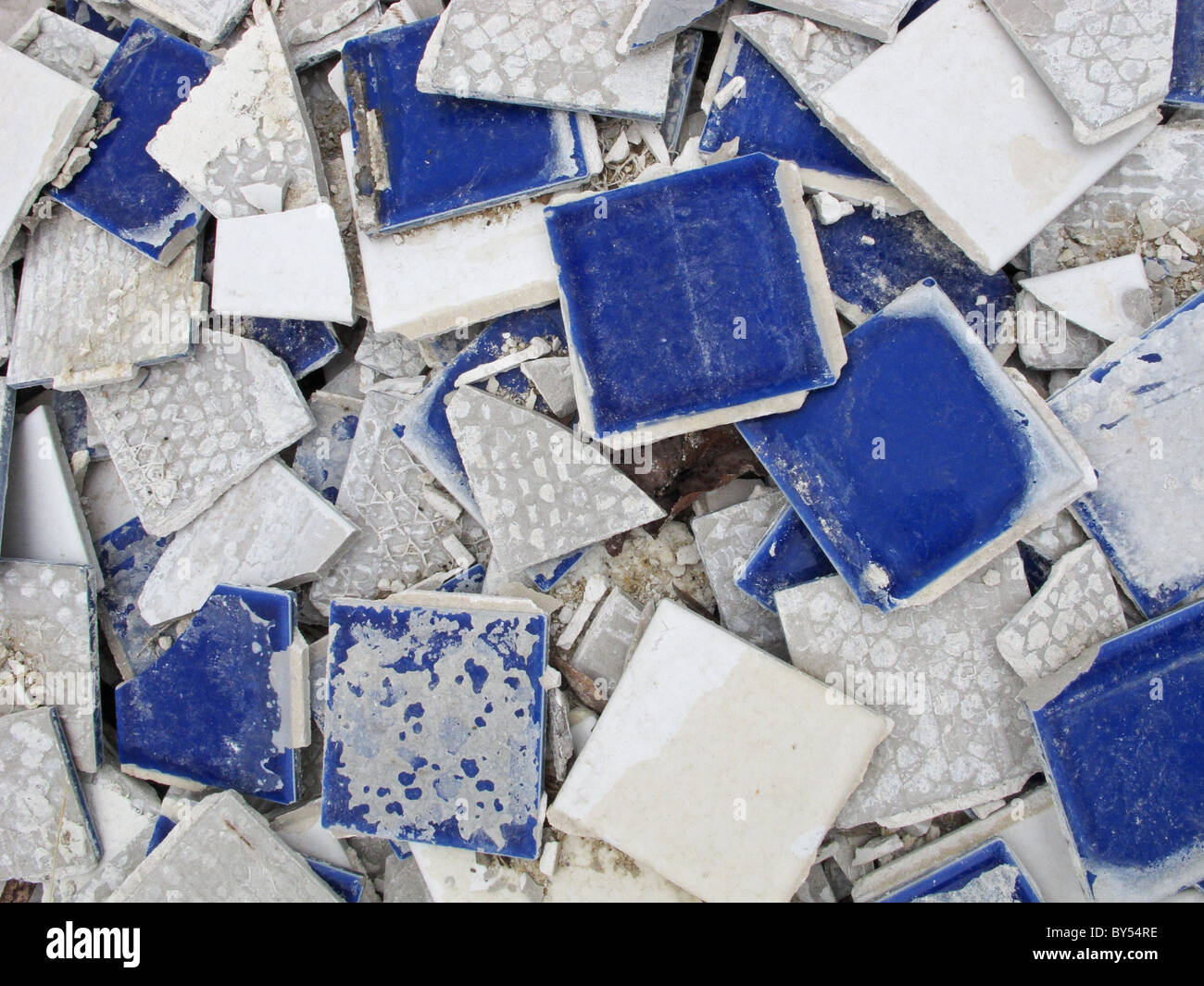 Broken, old blue bathroom floor tile - background Stock Photo