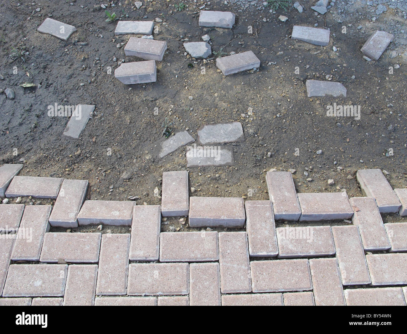 Bricks separating in the mud at a construction site Stock Photo