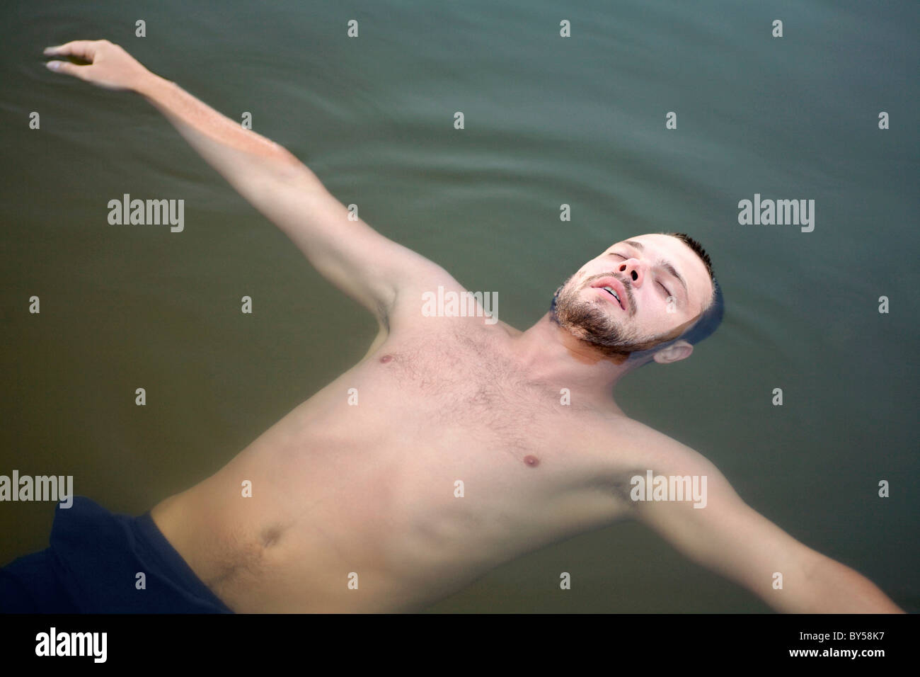 Man floating on water Stock Photo