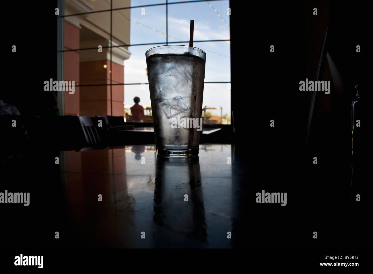 A glass of ice water on a table in a restaurant Stock Photo