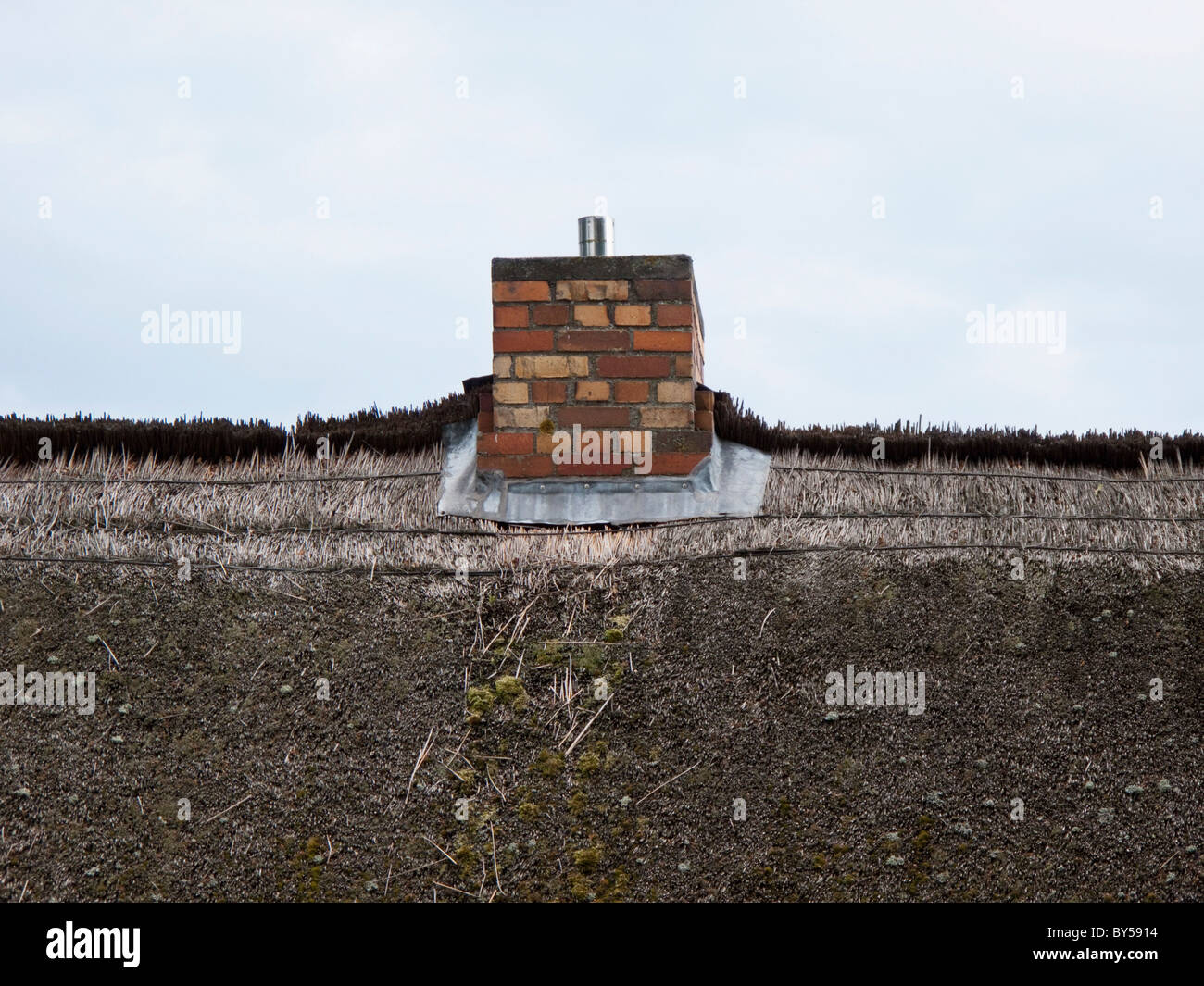 Thatched roof and chimney Stock Photo