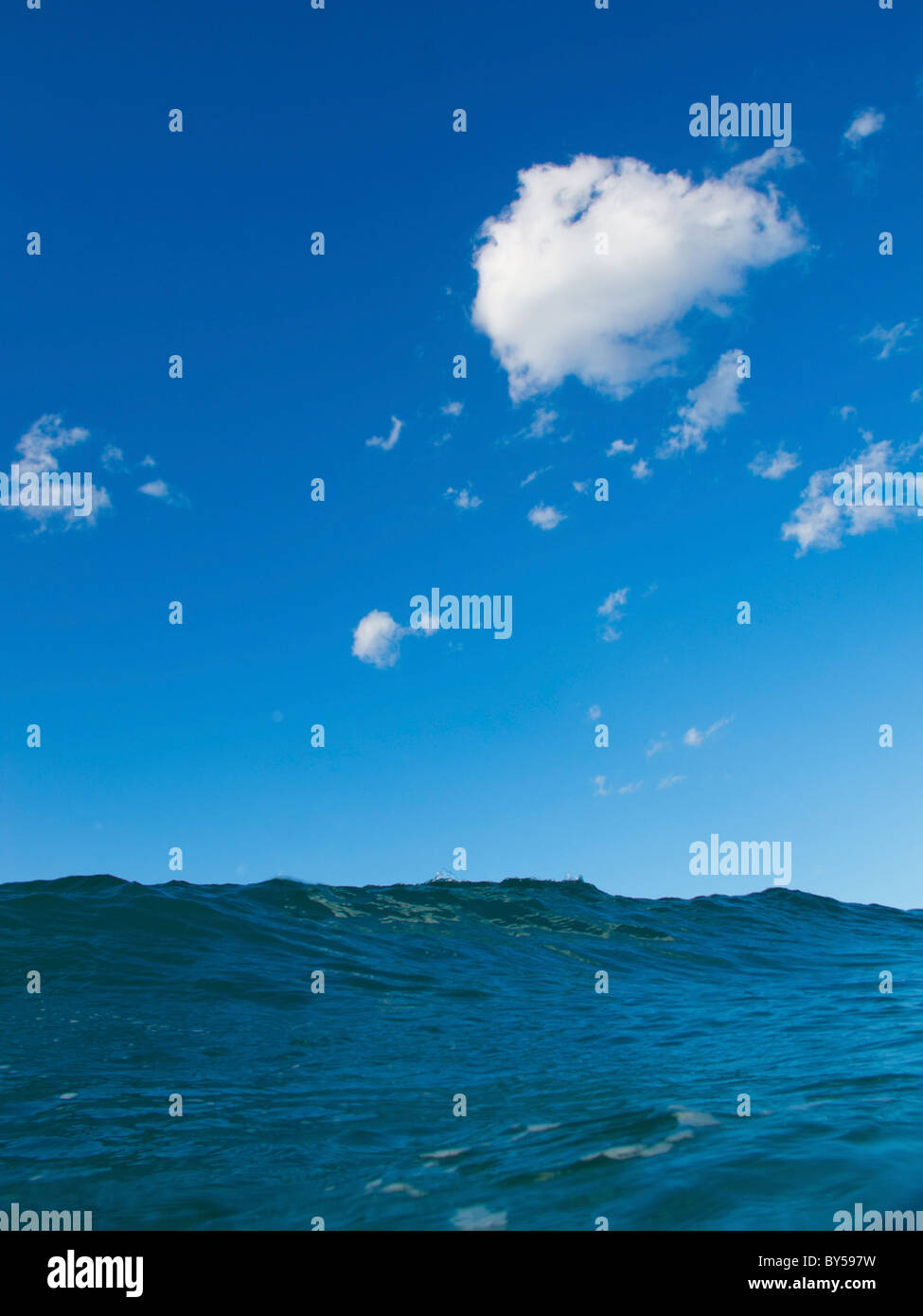 View of the sea with green water and blue skies Stock Photo - Alamy