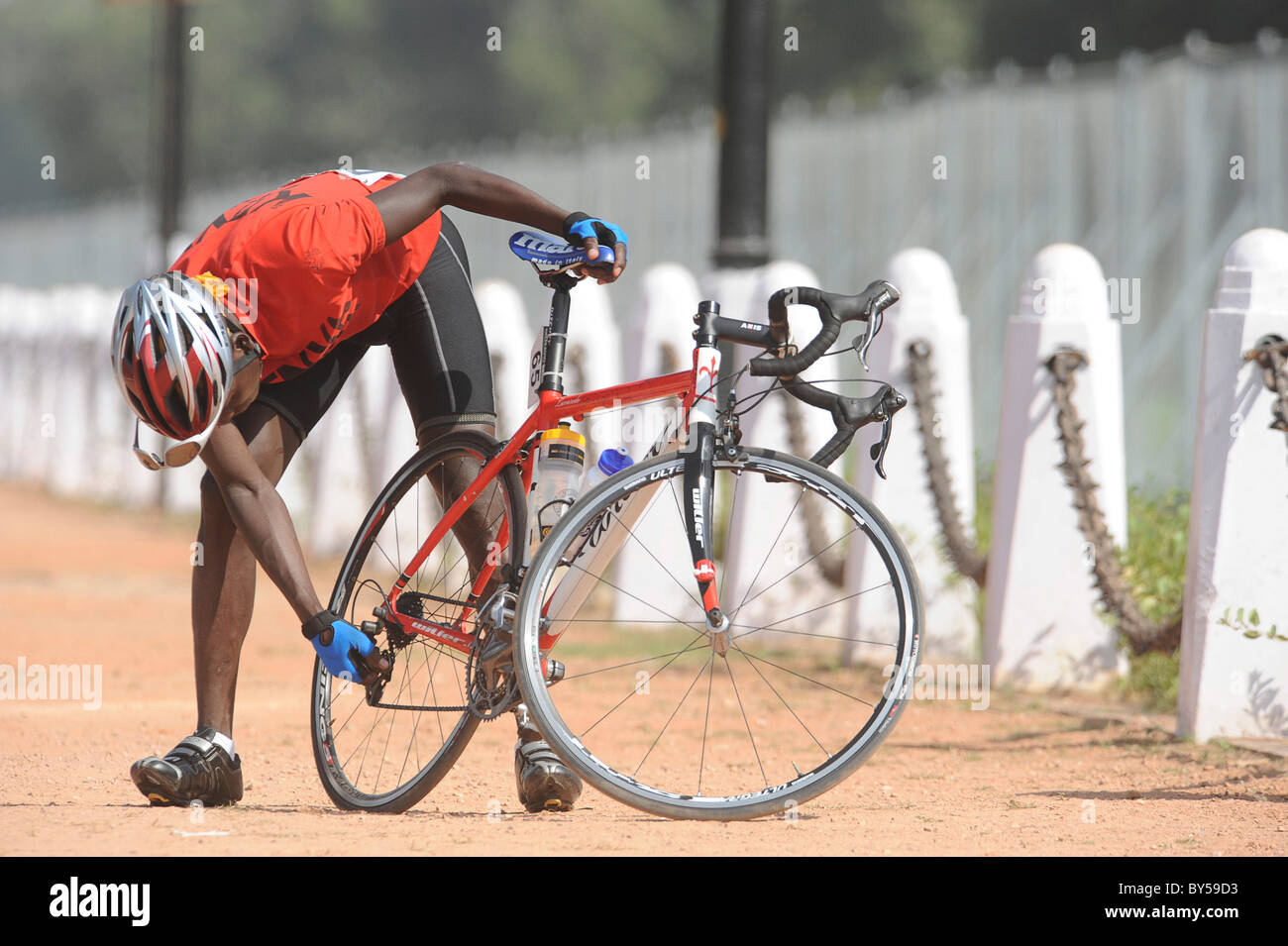 India Delhi 2010 XIX Commonwealth Games Road cycling event competitor  checking gears on his bike Stock Photo - Alamy