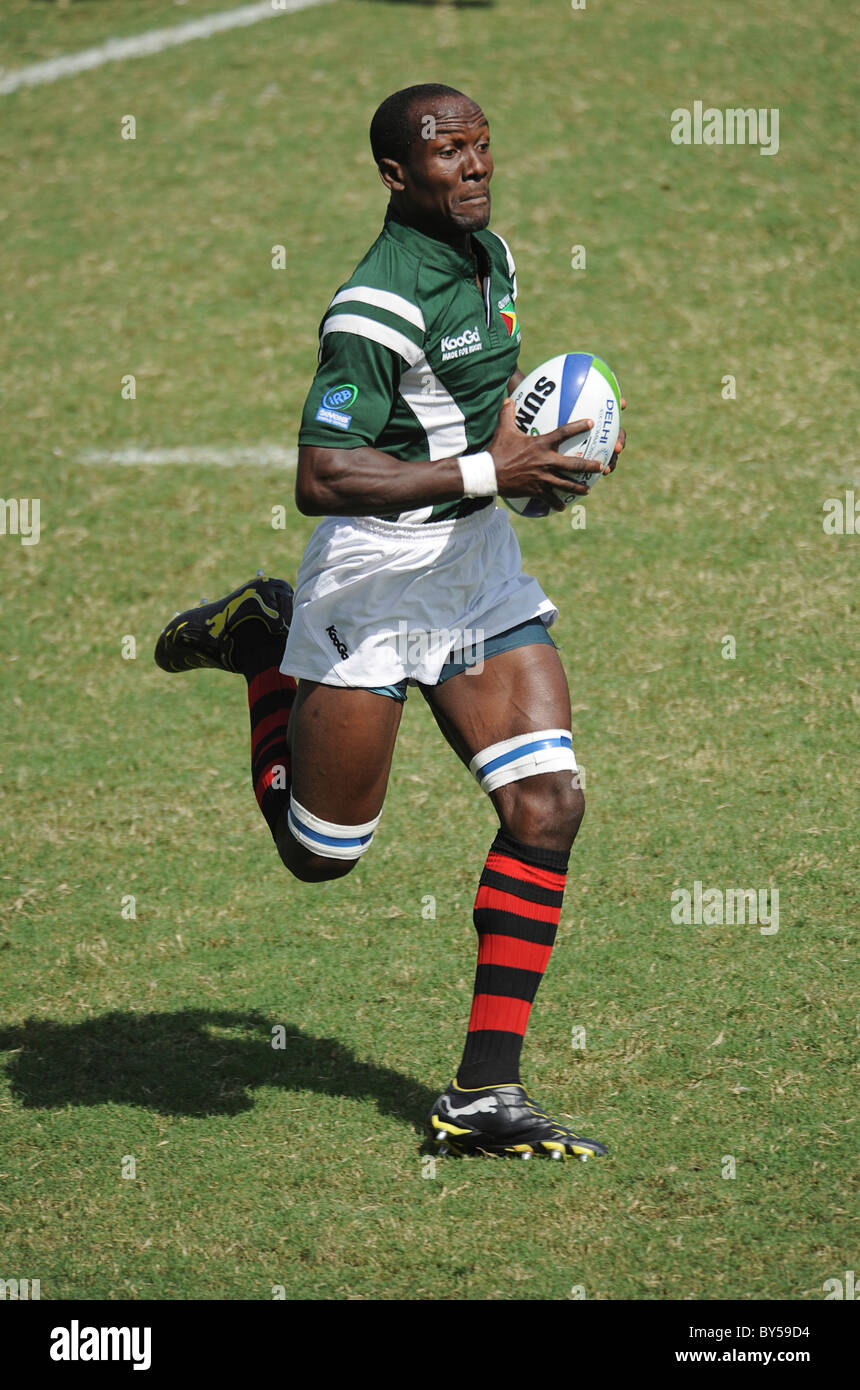 India Delhi 2010 XIX Commonwealth Games Rugby Sevens player running with ball. Stock Photo