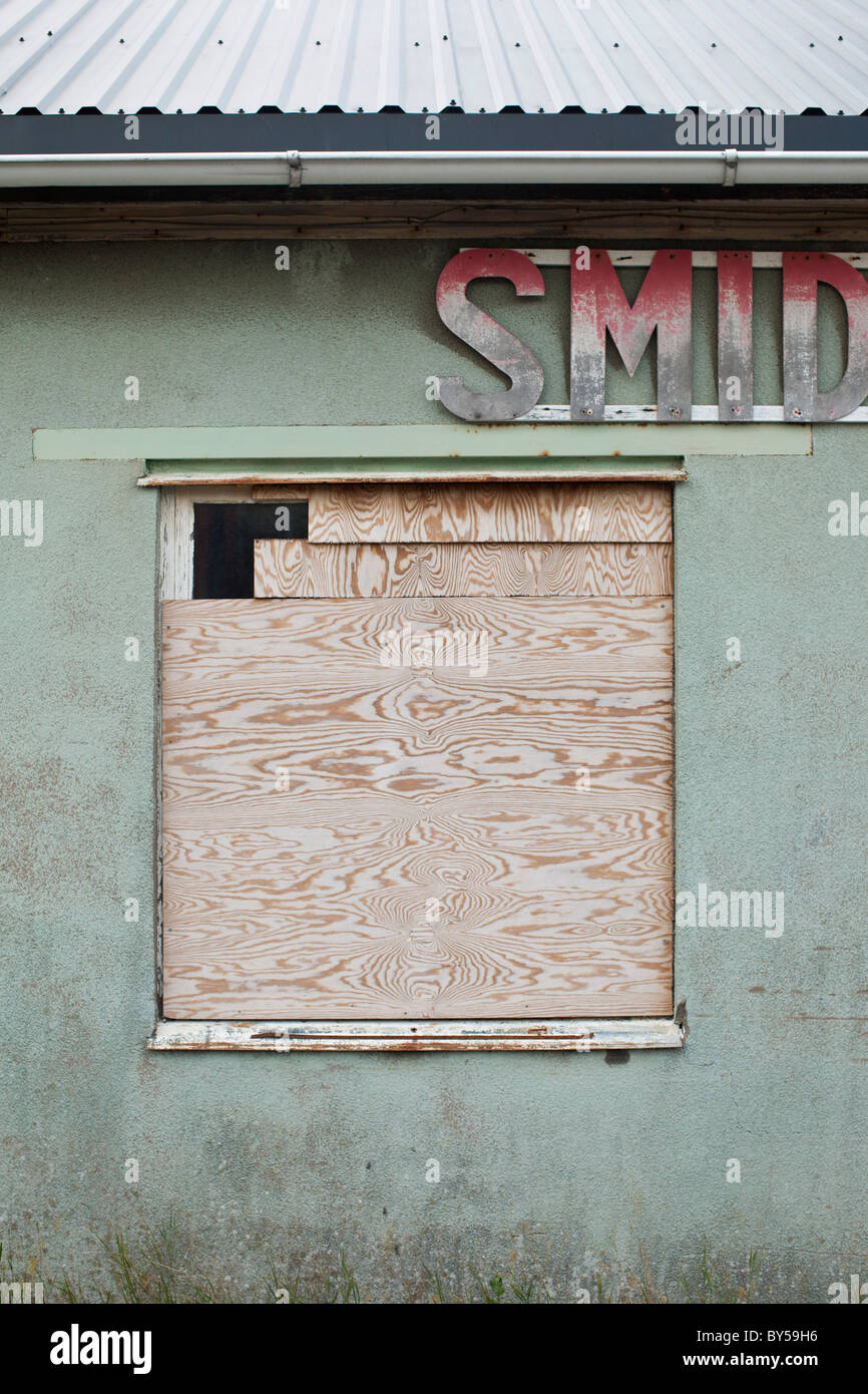A boarded up window of a run down building Stock Photo - Alamy