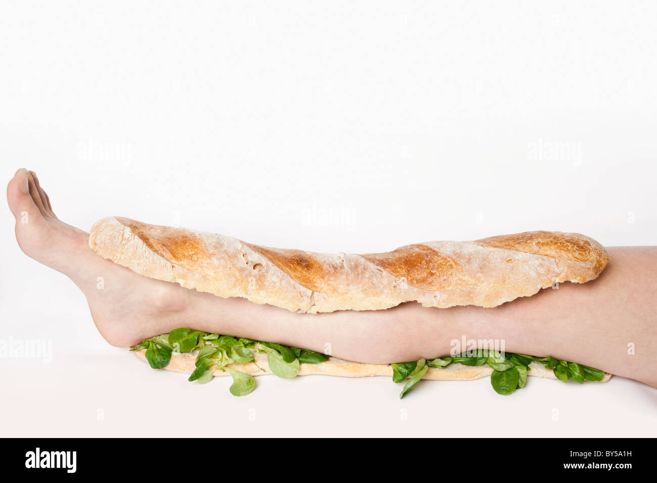 A submarine sandwich with a human leg in it Stock Photo