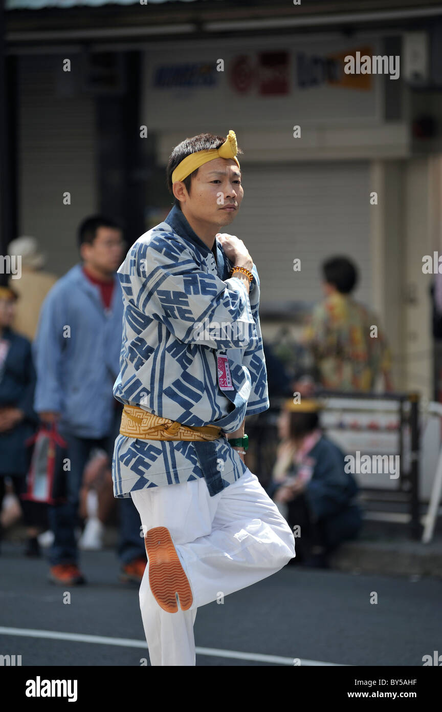 Young Japanese man in traditional outfit standing on one leg, Sanja  Matsuri, Asakusa, Tokyo, Japan Stock Photo - Alamy