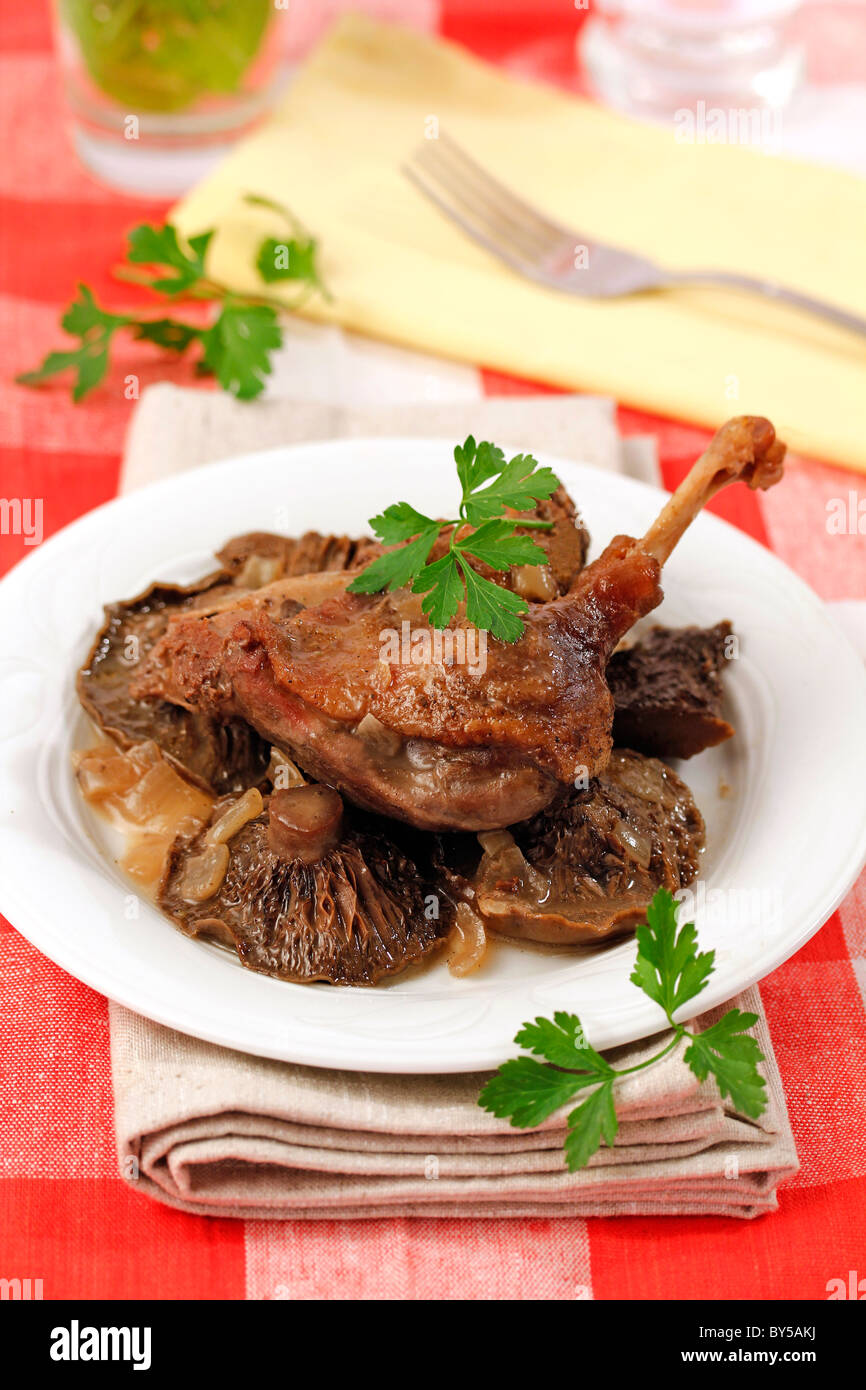 Confit de canard with mushrooms. Recipe available. Stock Photo