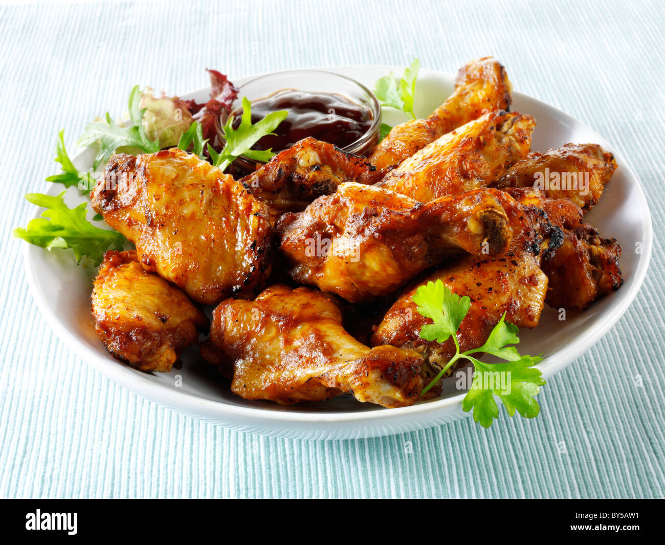 Bowl of spicy BBQ Chicken wings and thights. Stock Photo