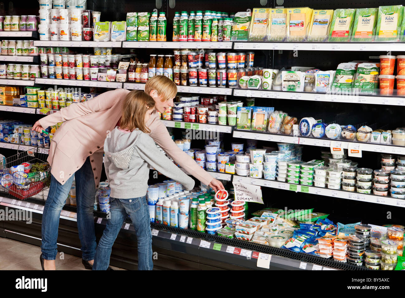 A mother and daughter shopping at the supermarket Stock Photo