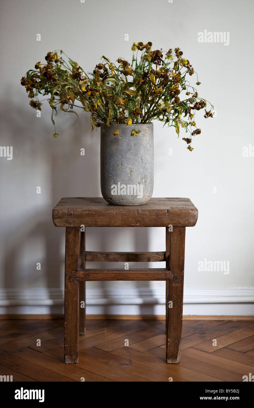 A stone vase full of dead flowers Stock Photo Alamy