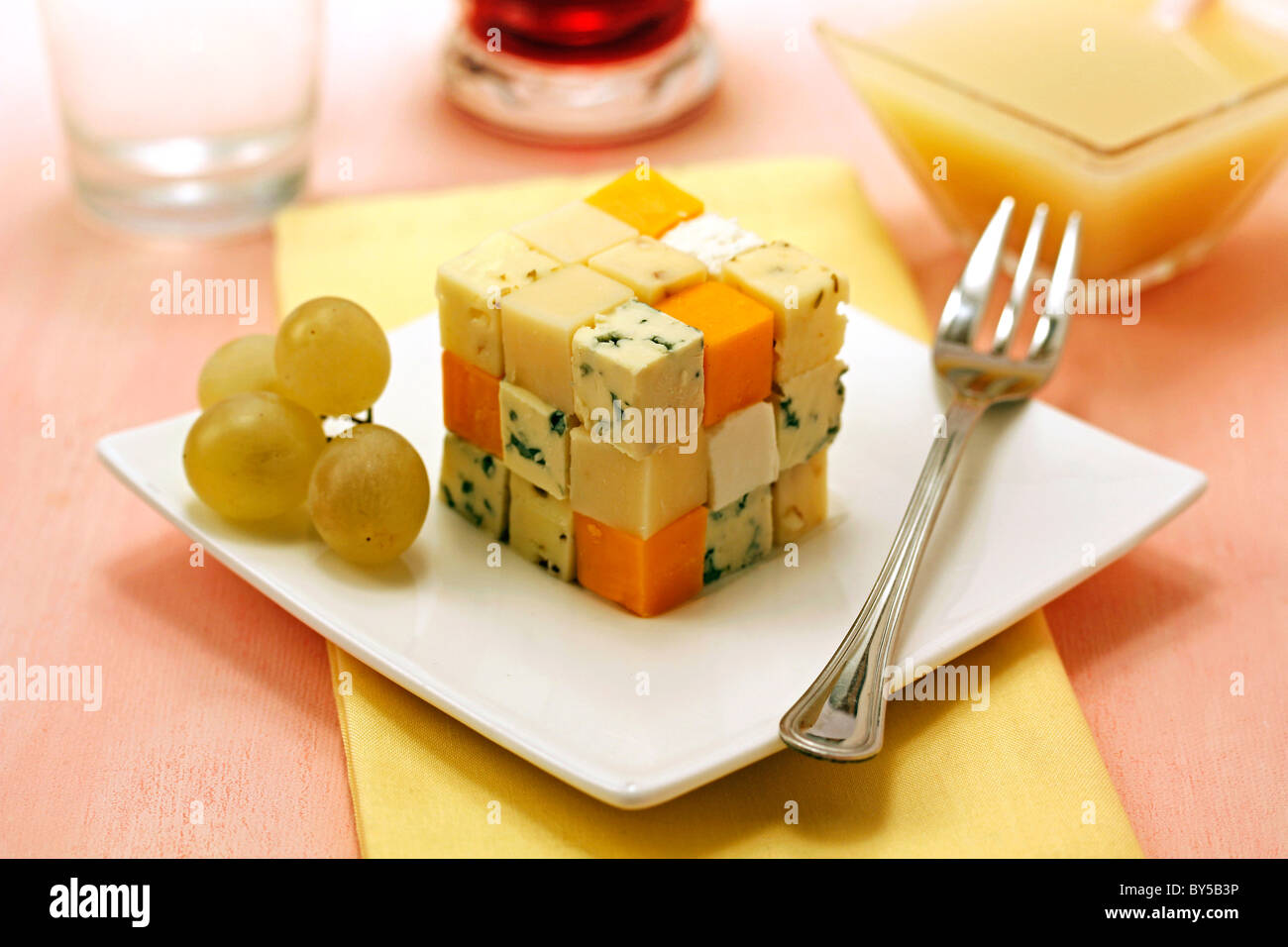 Cheese cube with grape coulis. Recipe available. Stock Photo