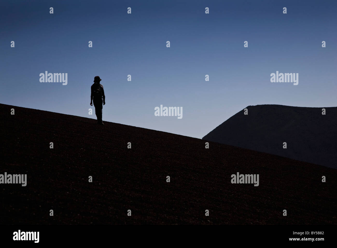 Silhouette of a person standing by Lonquimay Volcano, Patagonia, Chile Stock Photo