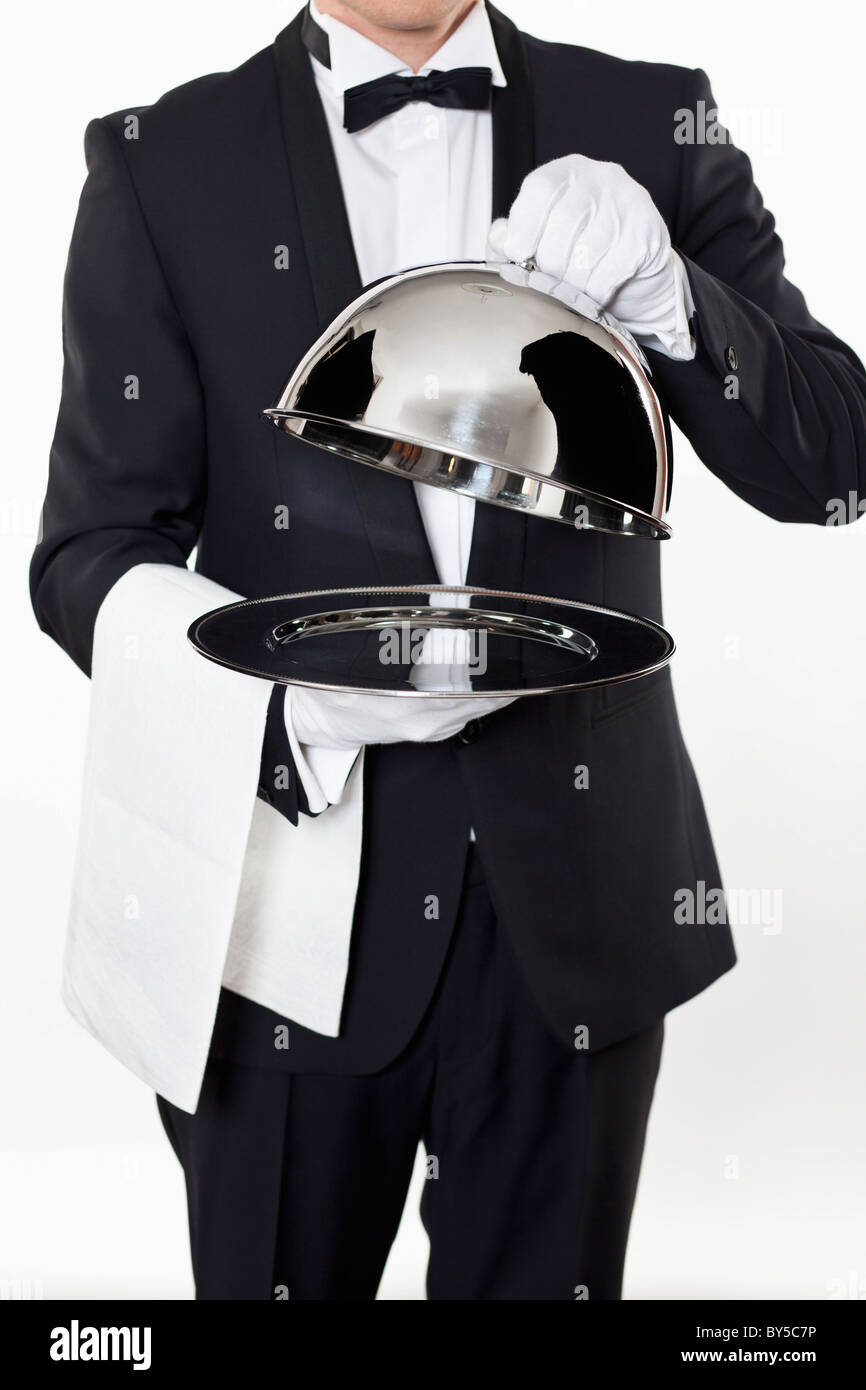 A butler taking the domed lid off an empty silver tray Stock Photo Alamy A butler taking the domed lid off an empty silver tray Stock Photo Alamy