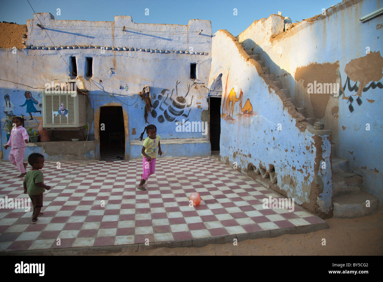 Young children playing football in Nubian village outside Aswan, Egypt Stock Photo