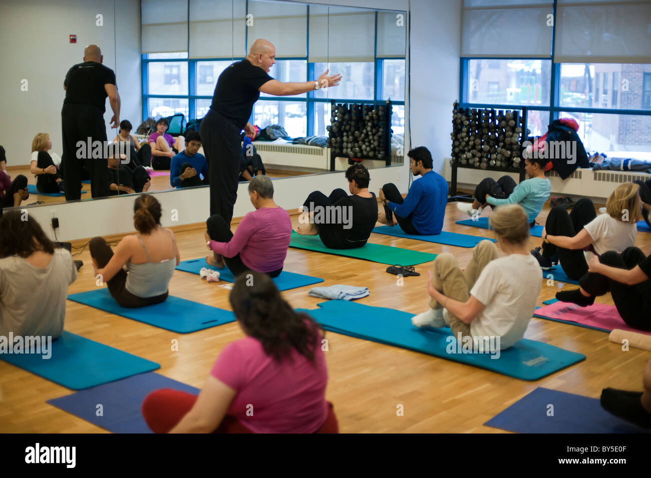 Exercisers participate in a pilates class at the Chelsea Recreation Center in New York Stock Photo