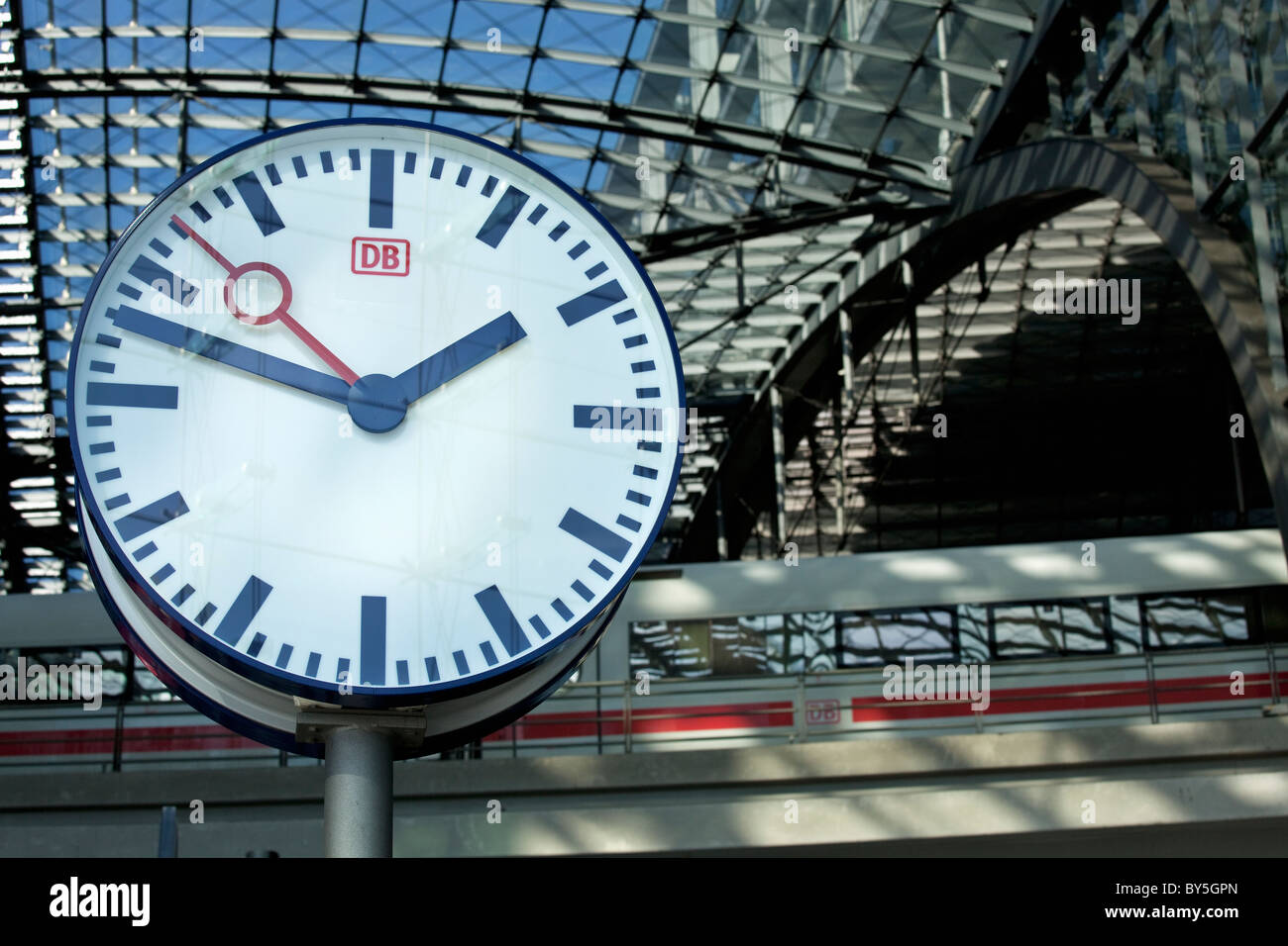 Germany,Berlin, Berlin Central Station, Lehrter Bahnhof, station clock and train Stock Photo