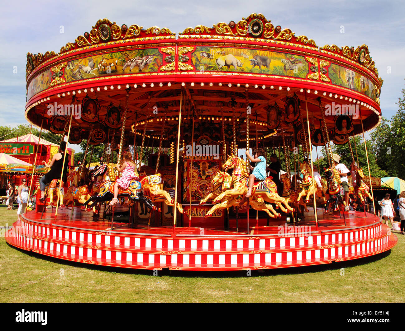 People riding on a carousel Stock Photo