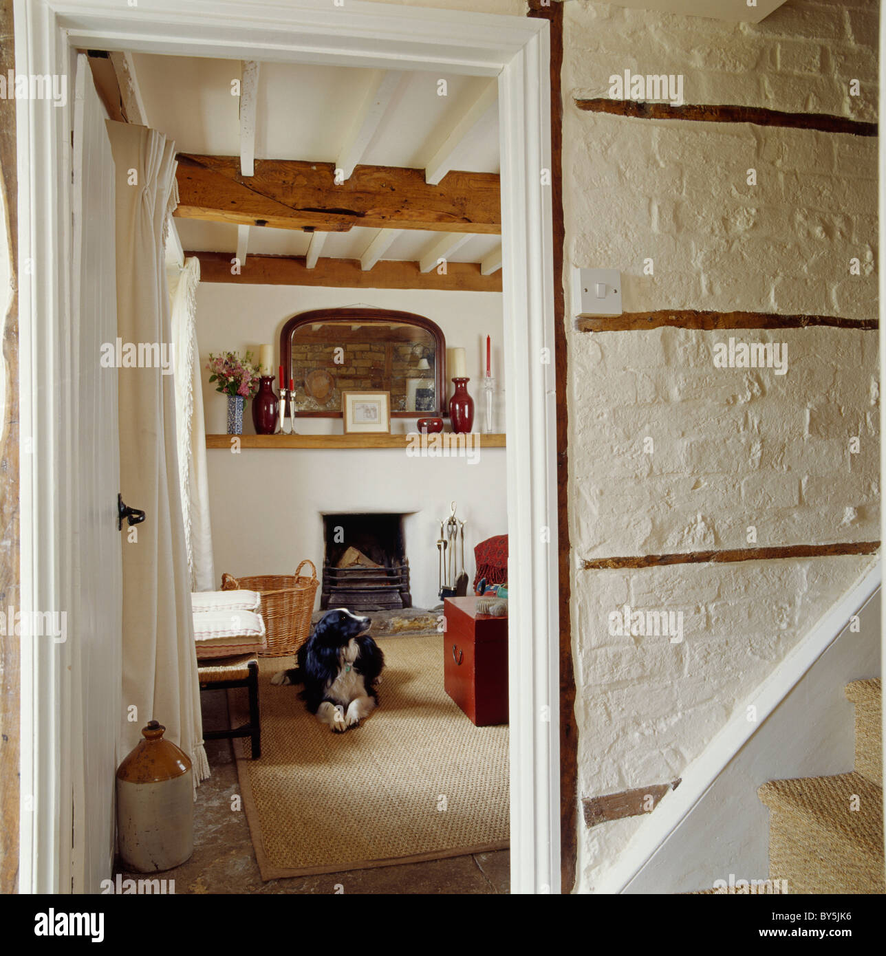 White Painted Brick Wall In Cottage Hall With Door Open To