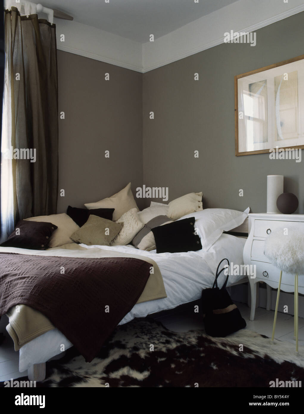 Cream And Beige Cushions On Bed With White Bedlinen In Dark