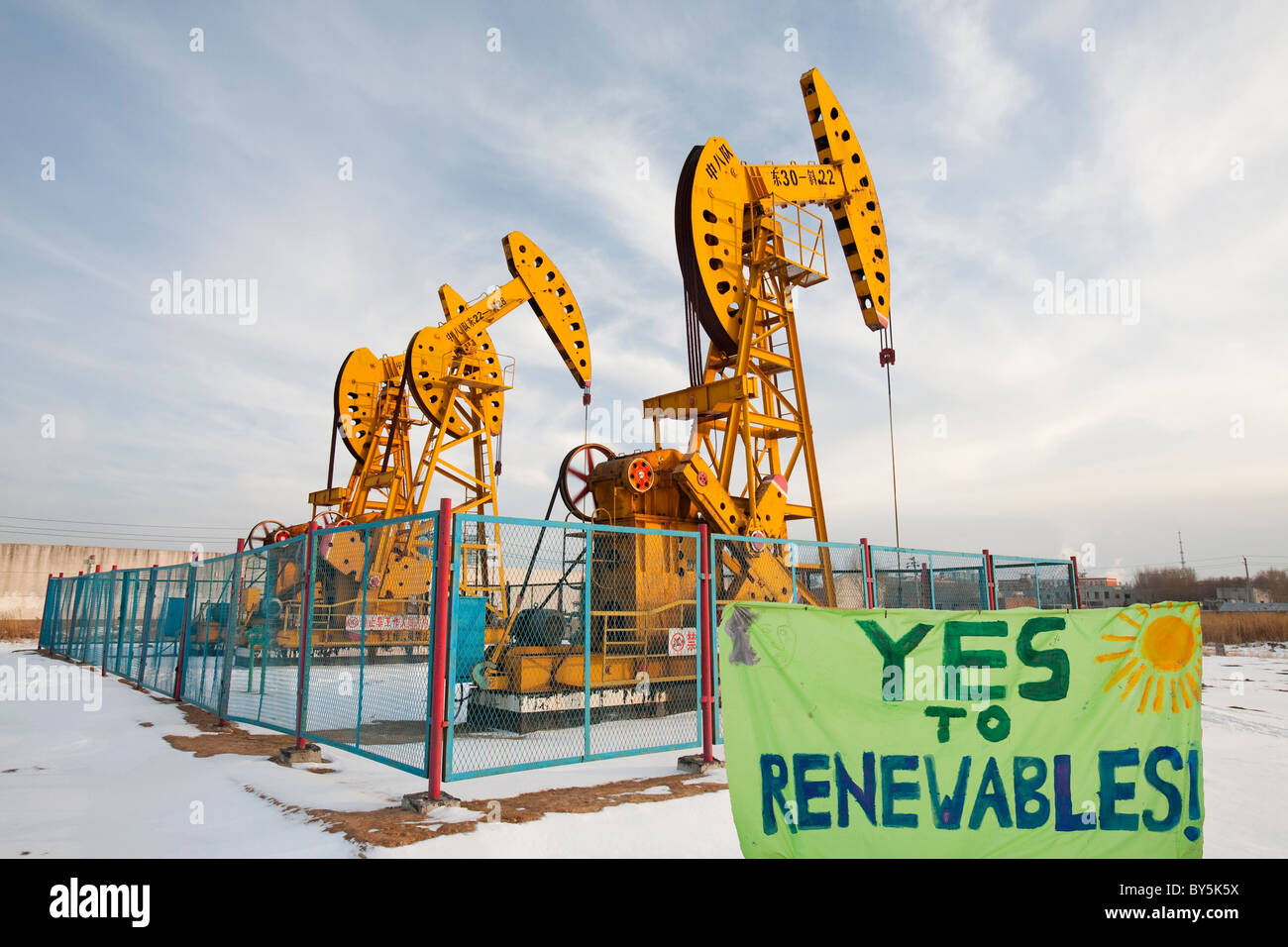Nodding donkey oil pumps pumping oil up from the Daqing oil field in Northern China. Stock Photo