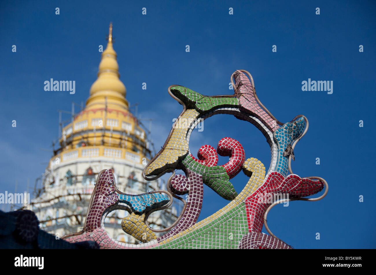 Malaysia, Island of Penang. Kek Lok Si Temple, ornate temple detail with main pagoda in distance. Stock Photo
