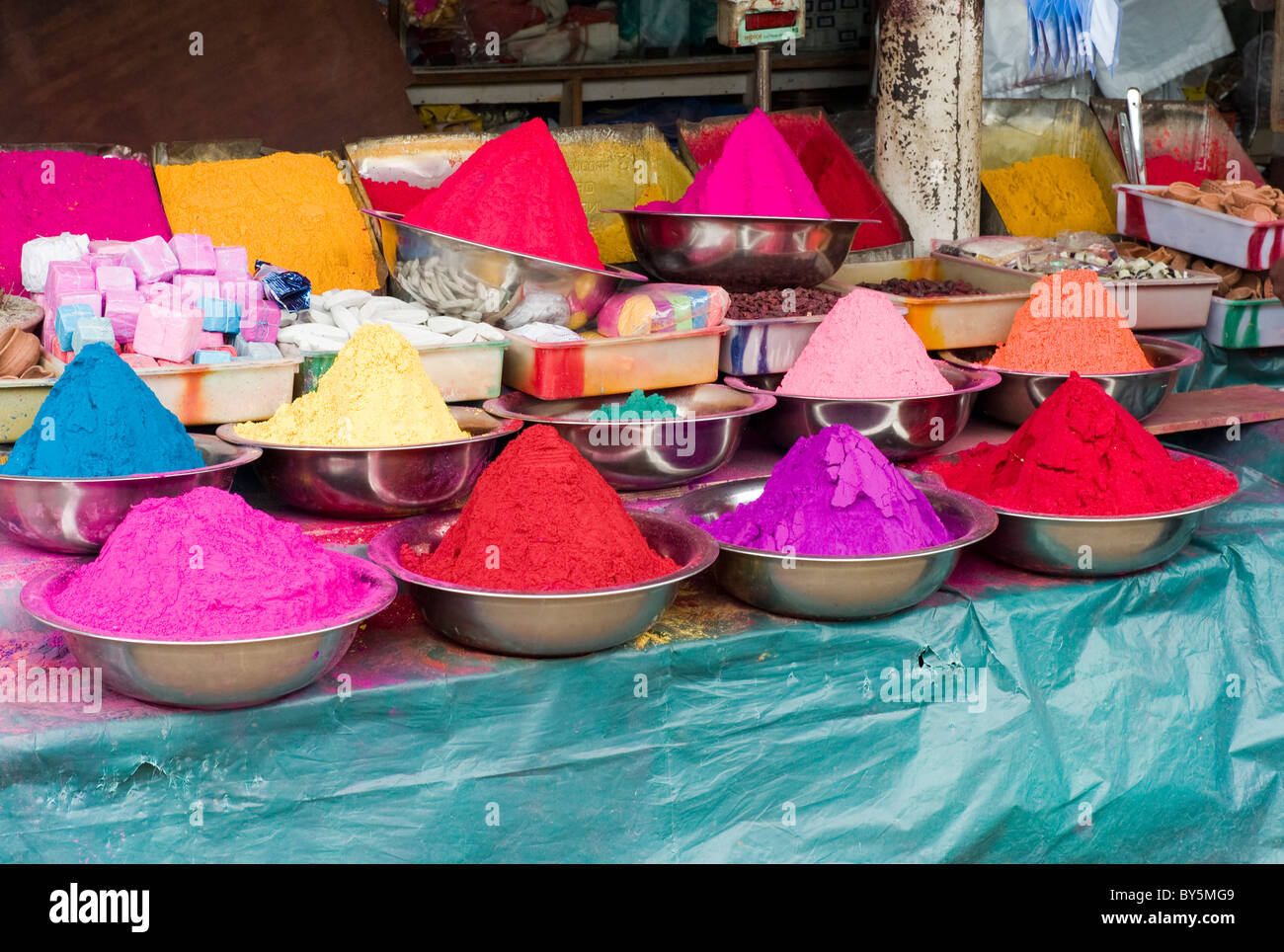 Conical piles of coloured dyes for sale in an open fronted shop at Mysore, Karnataka, India Stock Photo