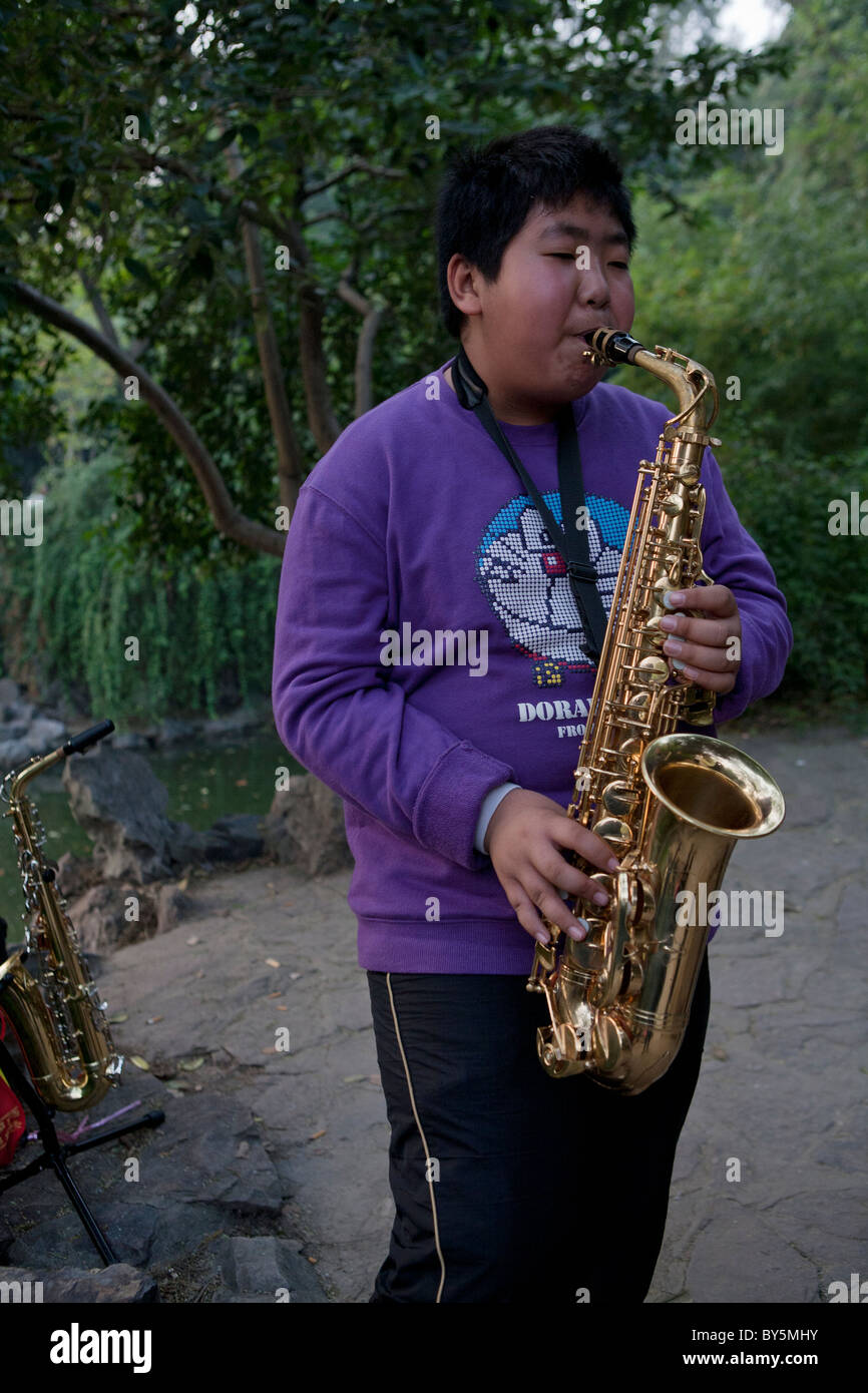 Boy playing saxophone hi-res stock photography and images - Alamy