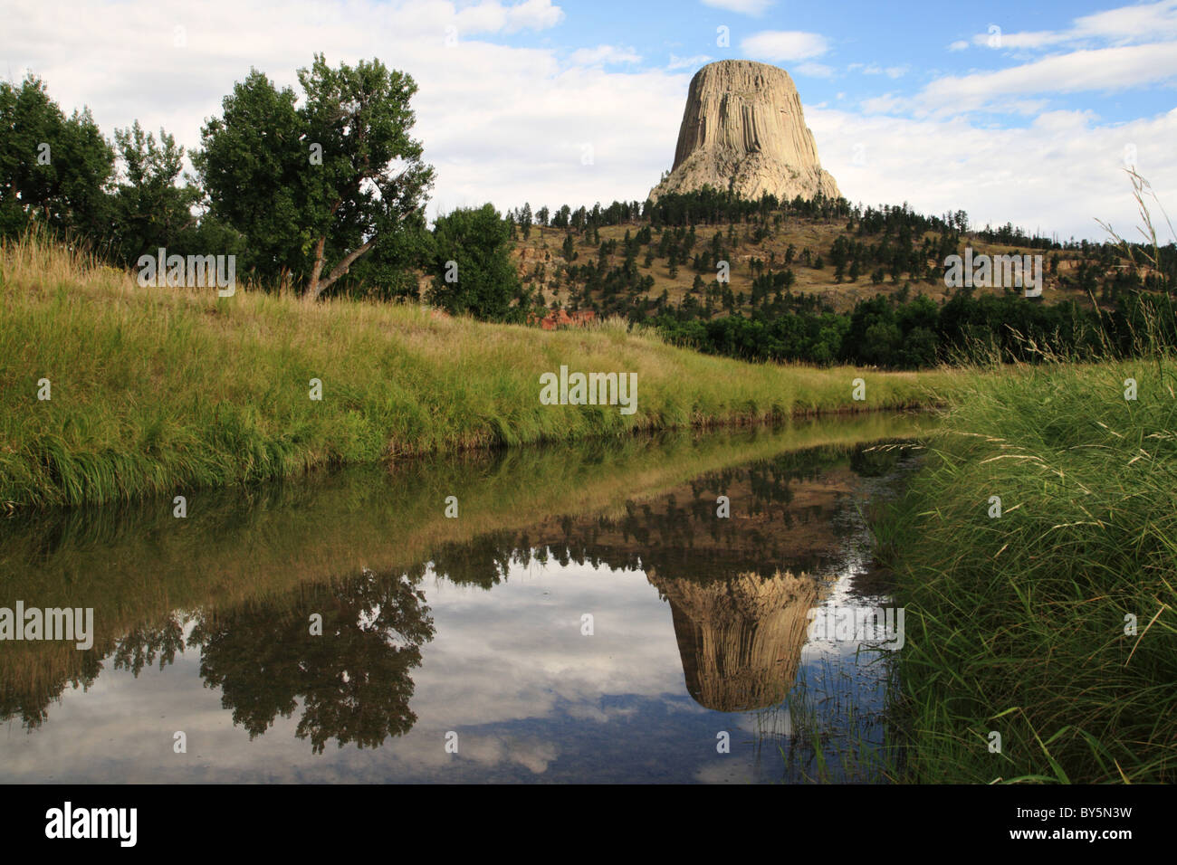 Devils Tower and its reflection in the Belle Fourche River Stock Photo