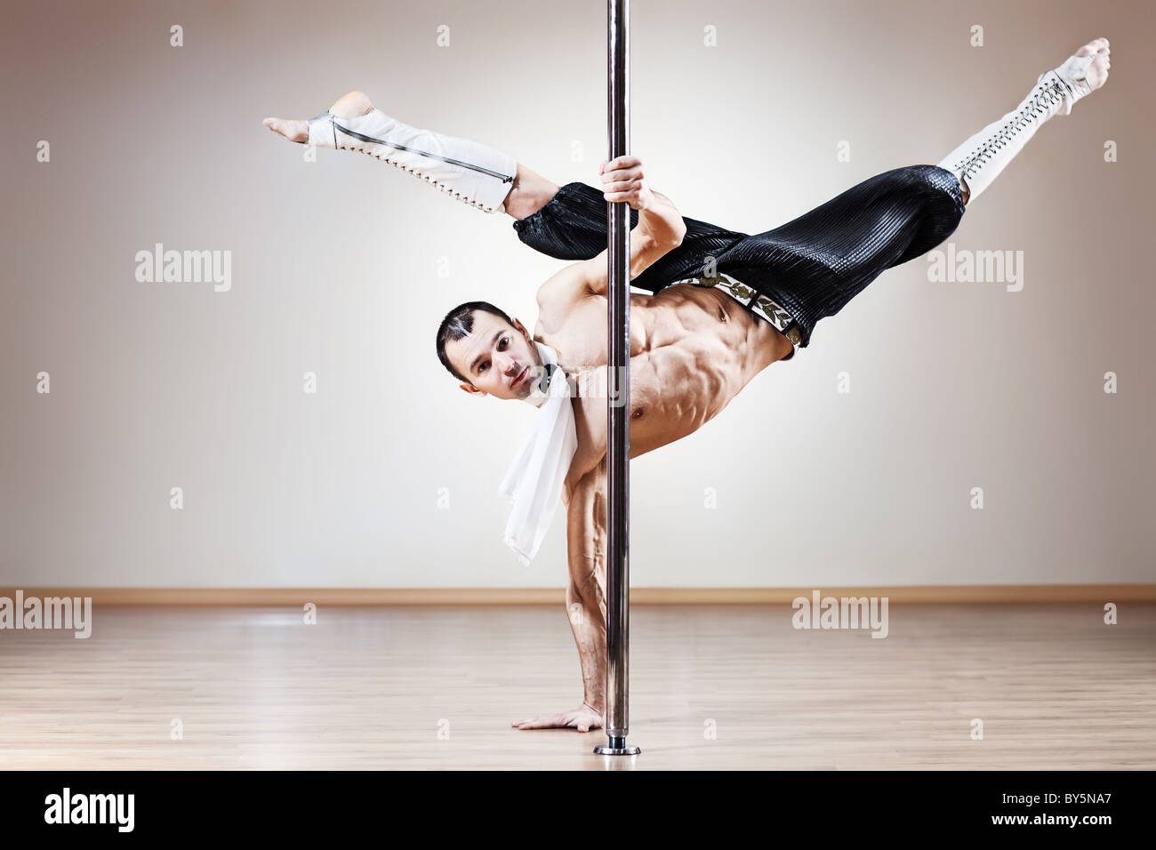 Young strong pole dance man. Stock Photo