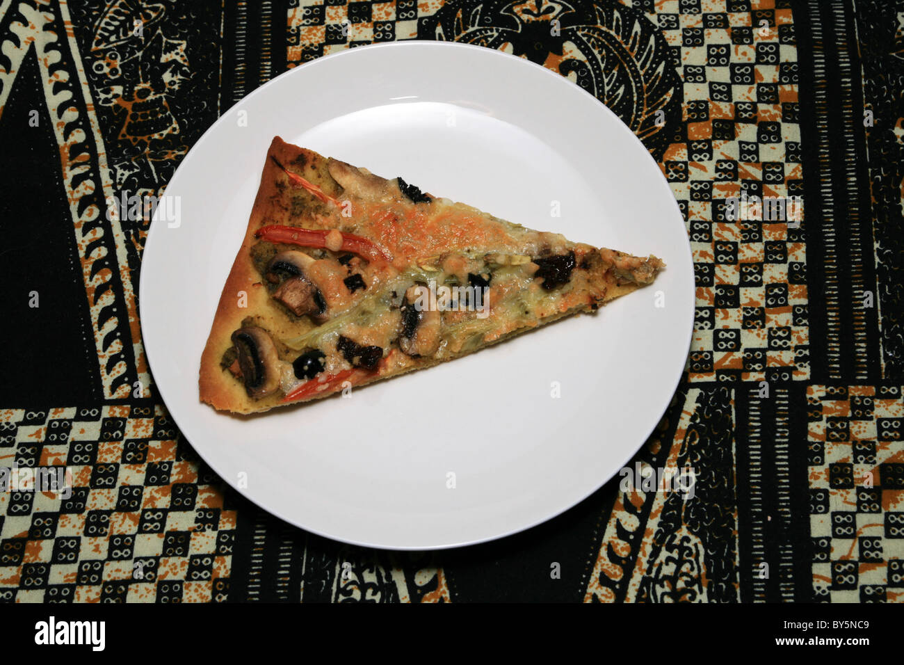 home made pesto pizza slice on a white plate Stock Photo