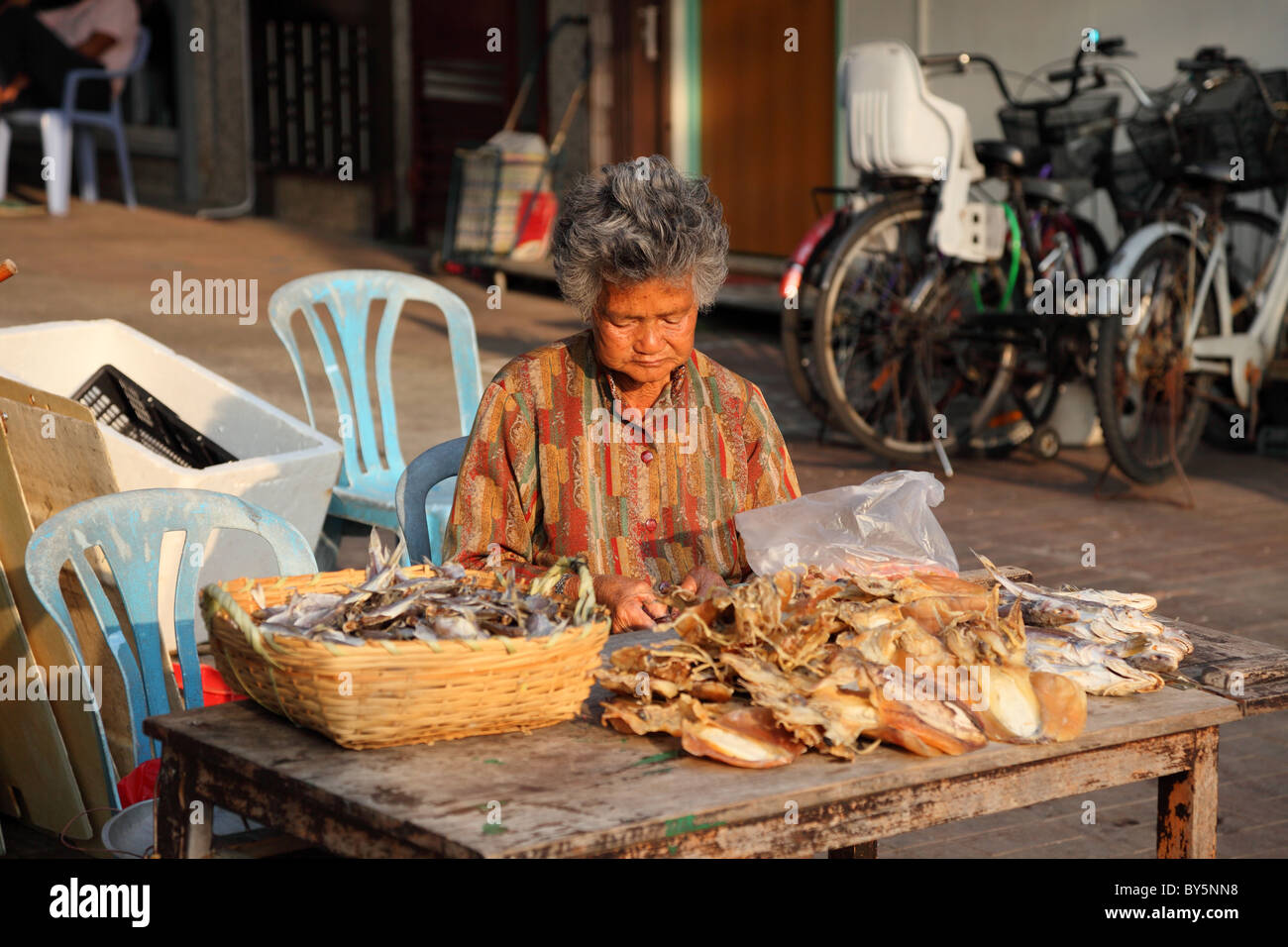 Woman selling dried fish at street market in Cheung Chau, Hong Kong Stock Photo