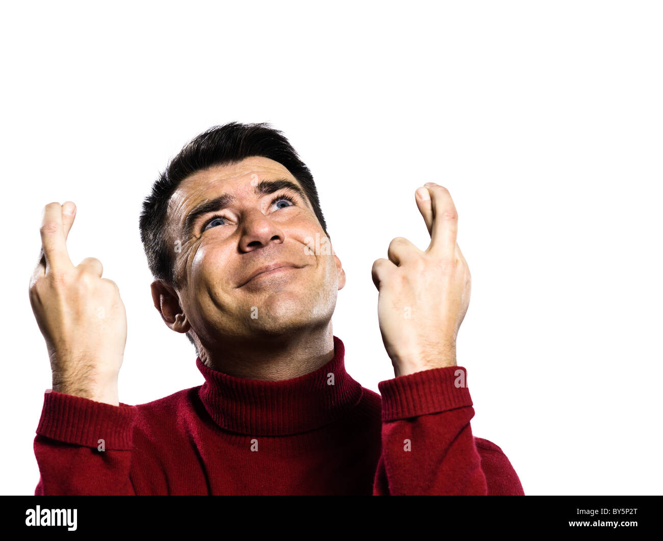 caucasian man finger crossed gesture studio portrait on isolated white backgound Stock Photo