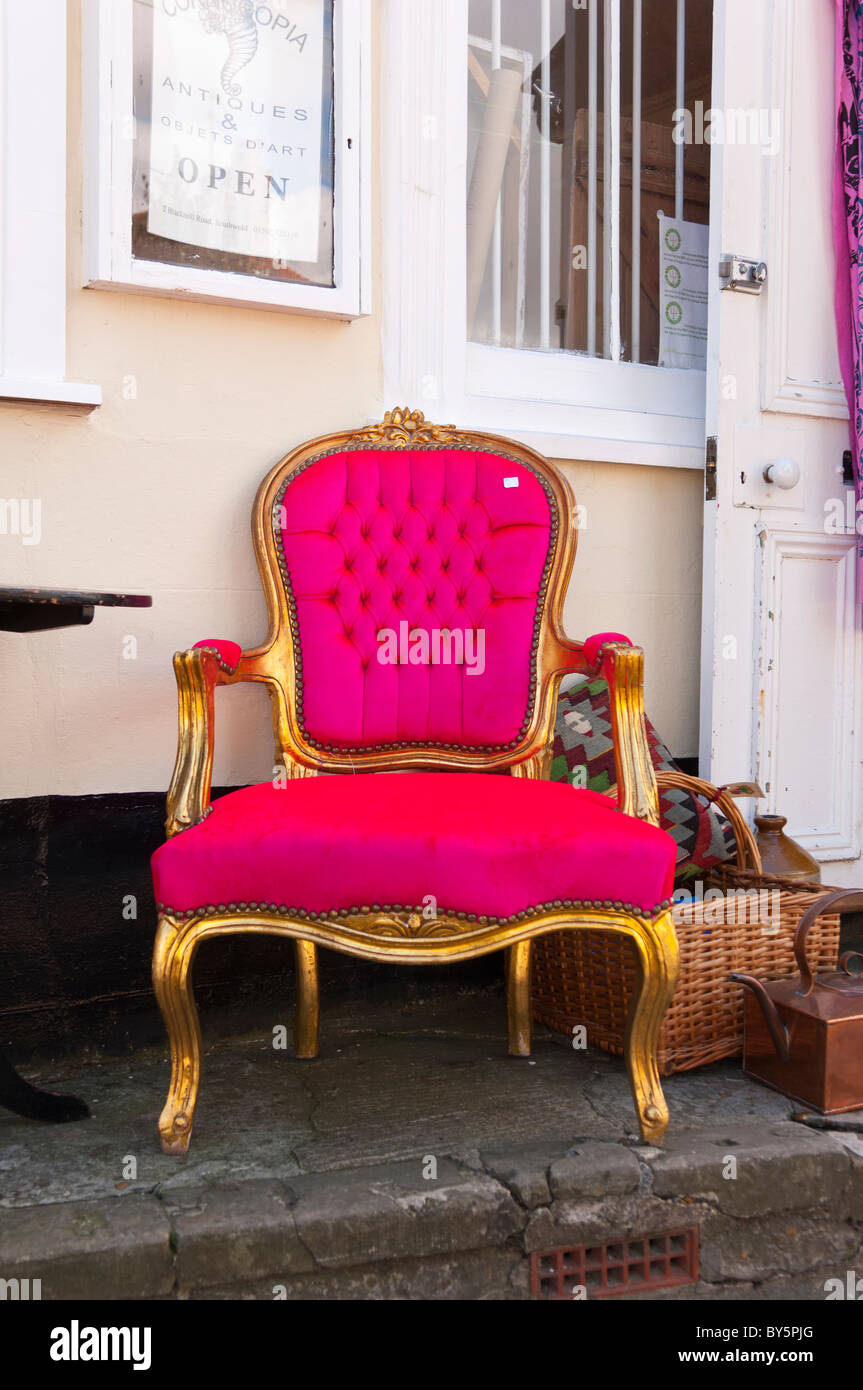 An Unusual Pink Throne Chair For Sale Outside An Antique Shop