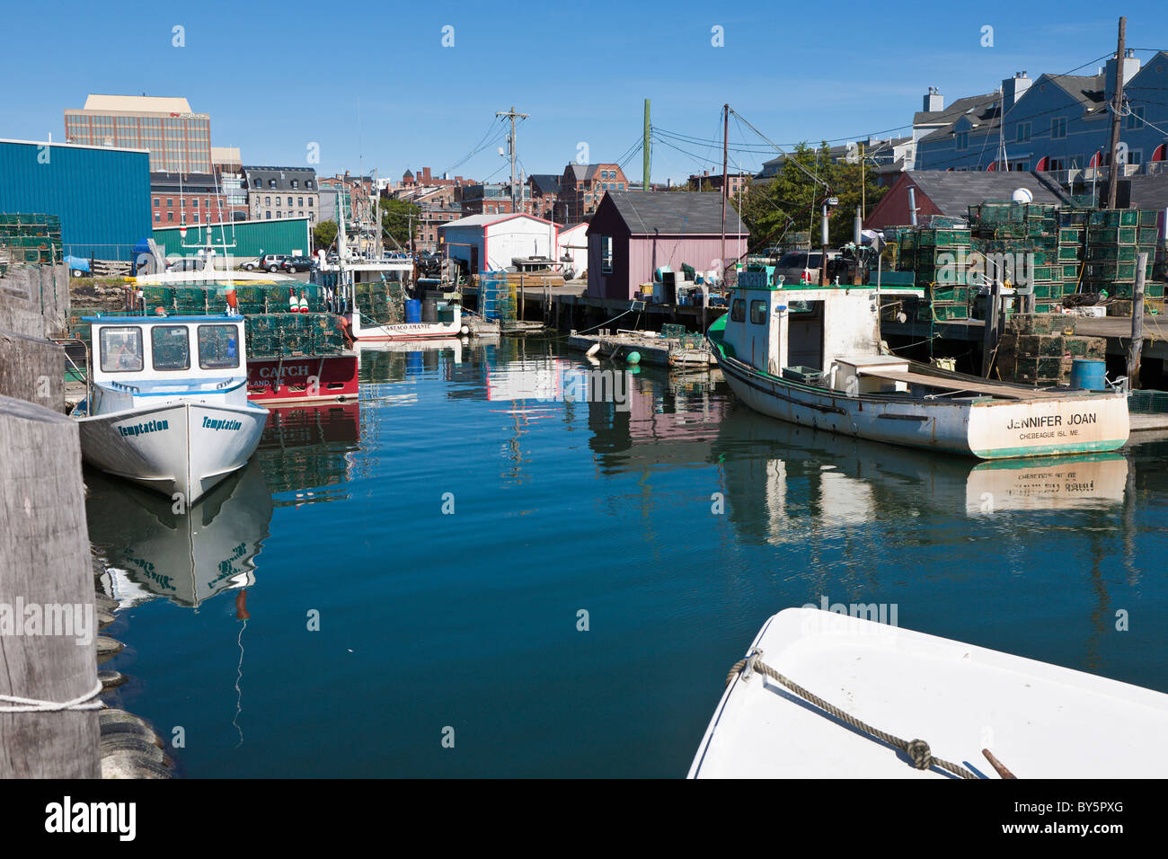 Commercial lobster fishing boats tied to pier in Portland, Maine Stock