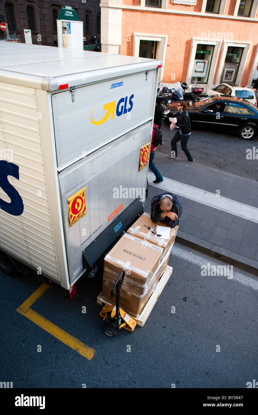person worker man boxes packages packs delivering transport Rome Italy ...