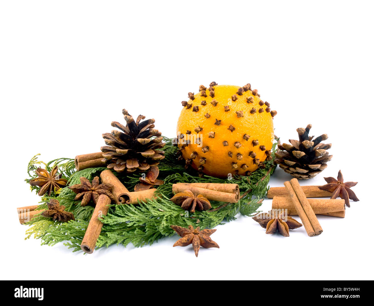 Christmas arrangement with thuja branches and orange with cloves on white background. Stock Photo