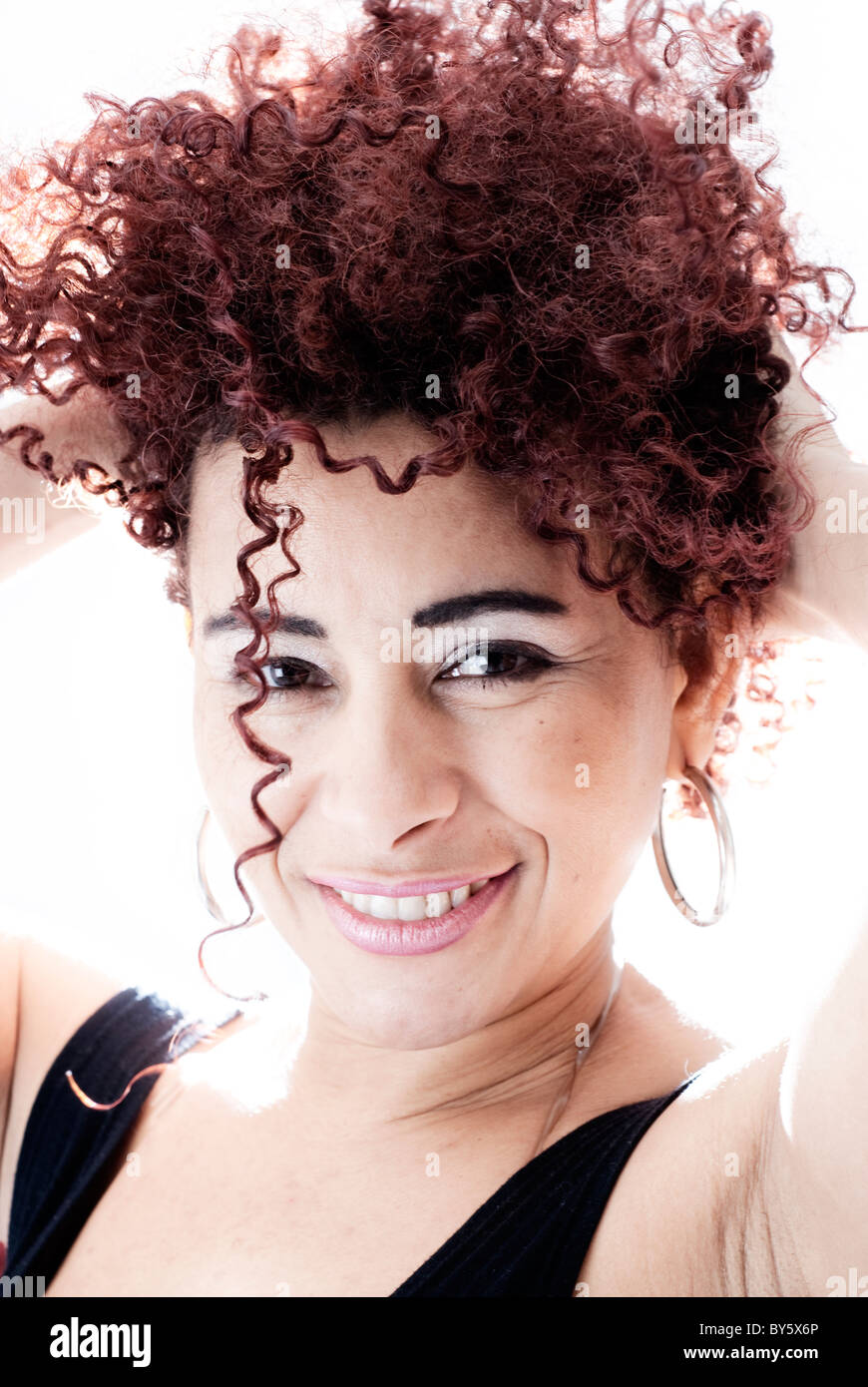 Brazilian Woman Smiling With His Hands On His Head Has Curly Hair