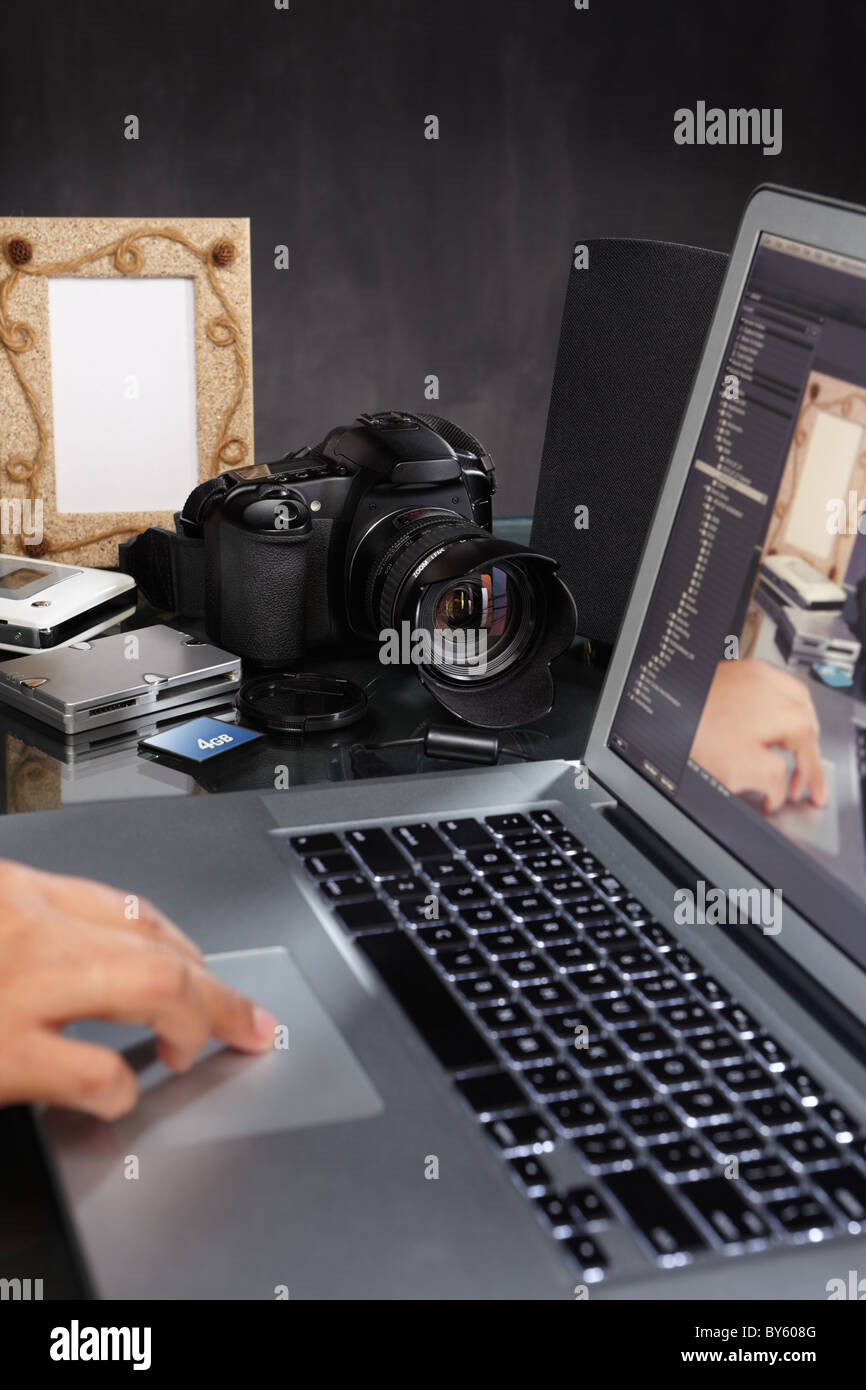 Working Still Camera Photographer still working on the photos using laptop Stock Photo - Alamy