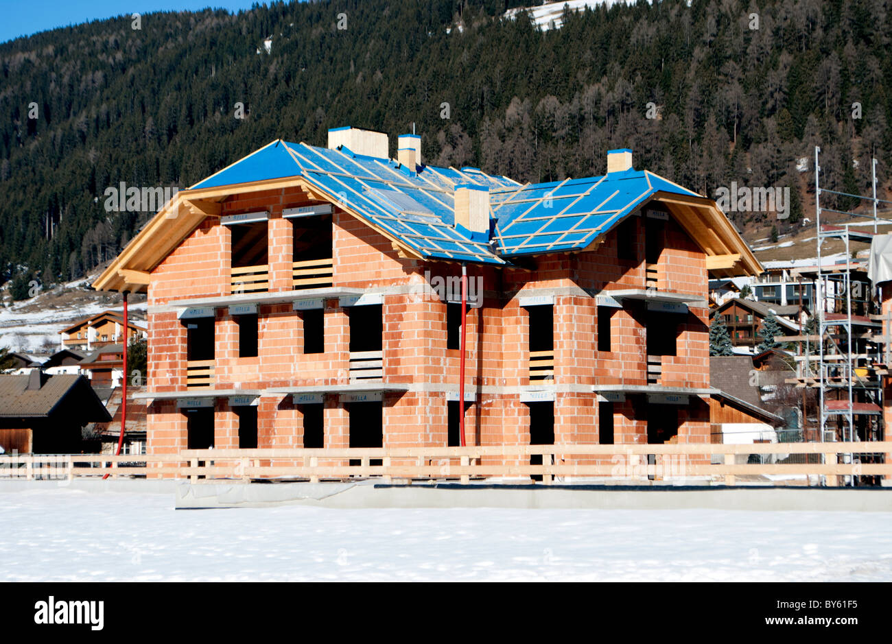 House Under Construction With Red Brick And The Mountain