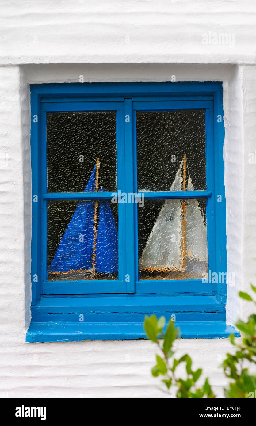 Two model sailing boats neatly framed behind a small window Stock Photo