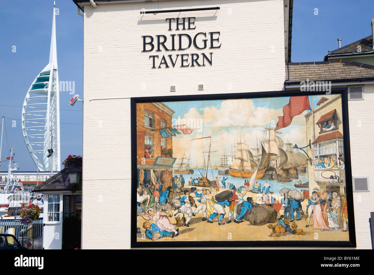 England Hampshire Old Portsmouth Harbour The Camber with Spinnaker Tower beyond Bridge Tavern with cartoon by Thomas Rowlanson Stock Photo