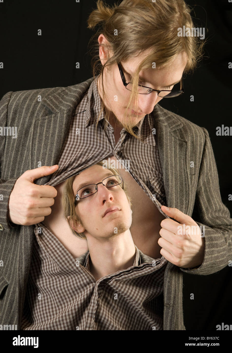 man opening shirt revealing a vision of himself Stock Photo